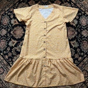 Locryz. Size small. Mustard color with white pattern.